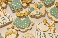 Hand-decorated baby shower cookie in soft greens and ivory with a touch of gold. Lovingly crafted for a sweet celebration. 